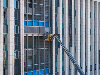 Construction Workers Installing Glass Windows on a Building