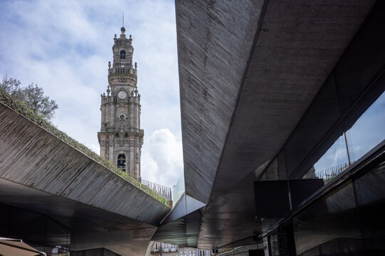 Historic bell tower framed by modern architecture