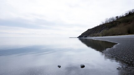 Serene Coastal Landscape: Tranquil Beach Scene with Calm Water Reflections