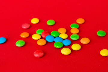 Pile of delicious colorful sweet candies on colored background top view. Confectionery decor