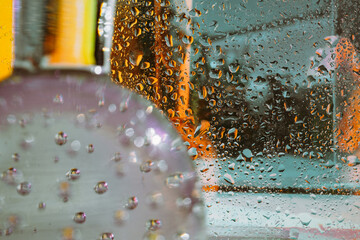 Close-up of droplets on glass bottle displaying vibrant colors