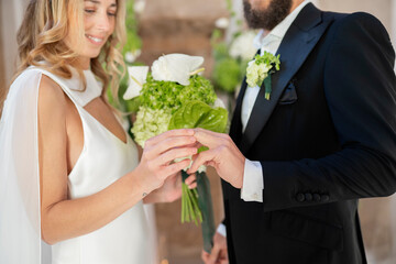 Bride and groom exchanging rings during wedding ceremony