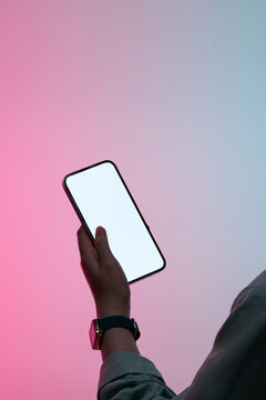 Person holding up a blank smartphone with a gradient background