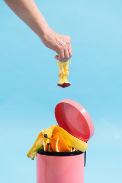 Food waste disposal, composting. Trash can on blue