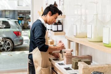 Worker in an artisanal soap shop preparing products
