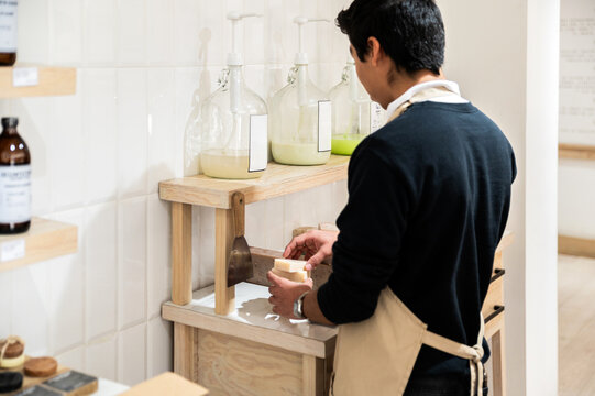 Artisan preparing soap in sustainable refill shop setting