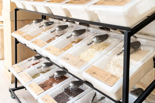 Bulk food bins with metal scoops in organized rows