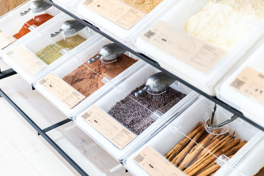 Various spices and herbs in containers at a refill store