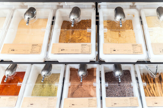 Assorted bulk spices and herbs in transparent containers