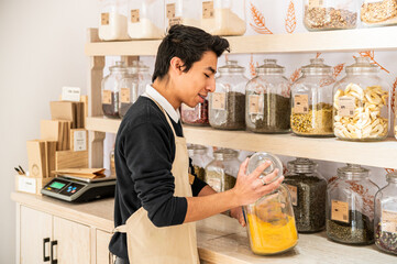 Worker organizing jars in a zero-waste bulk food store