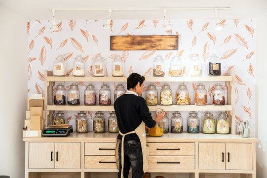 Bulk goods display in zero waste store with organized jars