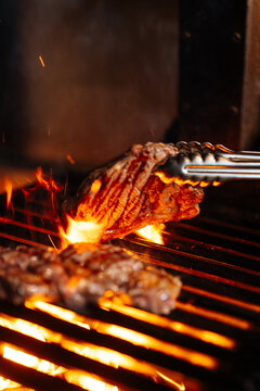 Grilling Steak Over Open Flames