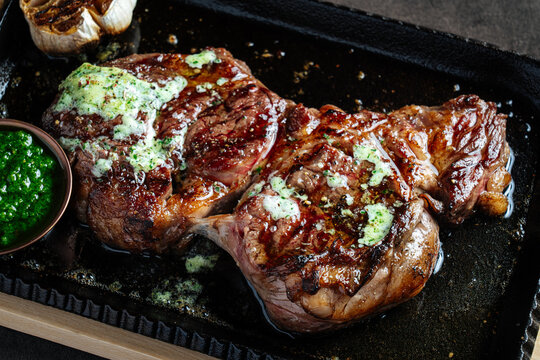 Grilled Ribeye Steak with Herb Butter and Chimichurri