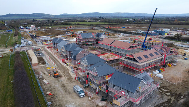 Looking down from an aerial drone shot of solar panels on new houses