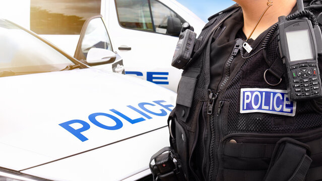 Police officer and police car - scene of emergency services cop with police force road vehicles, featuring a law enforcement car and police truck in response to an incident.