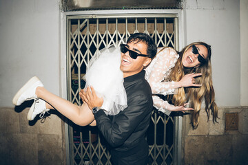 Newlywed couple in rebel attitude at night