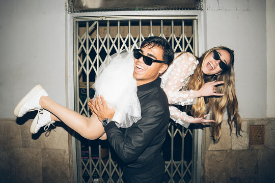 Newlywed couple in rebel attitude at night