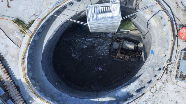 Crawler excavator enters tunnel in circular shaft