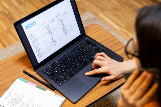 Woman checking her holidays travel list on computer screen