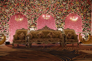 Luxurious Wedding Stage With Floral Backdrop and Lavish Seating Arrangement