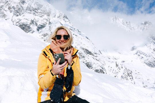 Woman on a Snowy Mountain Video Calling on the Phone