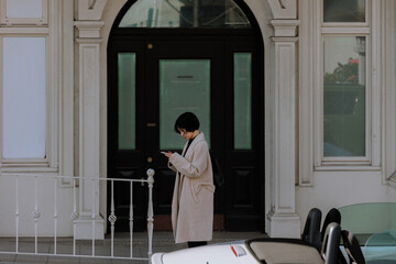 Tech Daily in the City: A Woman Checking Her Phone on the Street.