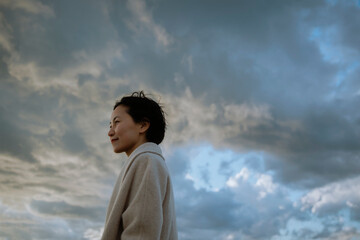 A woman calmly facing a sudden change in weather. 