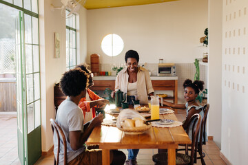 Family breakfast: Parents and kids enjoy a traditional Brazilian meal at home