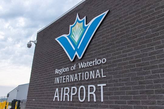 Waterloo, CANADA - Aug 5 2024 : Close-up of Region of Waterloo International Airport's logo and name on a brick exterior wall, captured from a low angle.