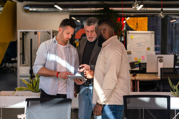 Collaborative team reviewing project in modern office