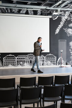 Speaker on stage in empty conference room