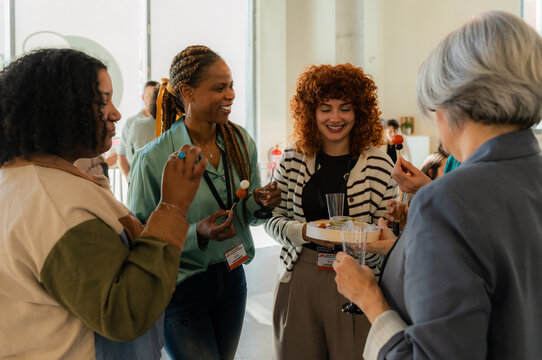 Group of professionals networking at a social event at the office