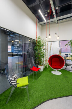 Modern office lounge with vibrant seating and greenery