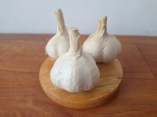 Fresh garlic bulb. Garlic is a culinary and medicinal plant with numerous health benefits, including boosting the immune system, reducing cholesterol, and potentially lowering blood pressure