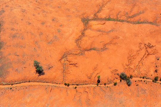 Dried creek beds running though red desert landscape