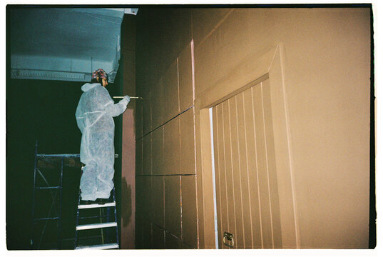 The woman is repainting the walls 