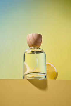 Elegant perfume bottle with a natural wooden cap and a lemon slice