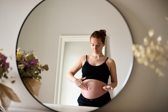 Skincare Routine for Expectant Mother in Mirror