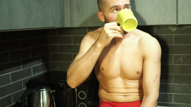 Young attractive man drinking coffee in the morning.