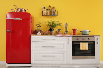 Interior of kitchen with red fridge, counters and shelf