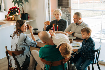 Family enjoying coffee and breakfast around holiday table
