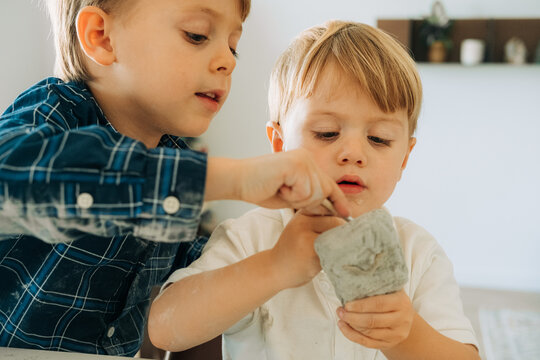 Young children working together on excavation clay kit