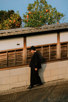 A Leisurely Woman in a Japanese Alley Under the Sunset Glow.