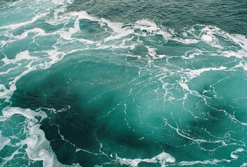 Turquoise ocean waves with foamy white patterns  
