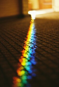 Rainbow light reflection on textured floor  
