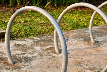 Close up round bicycle parking iron pole isolated on horizontal ratio outdoor park environment background.