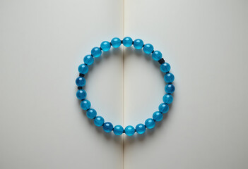 Elegant blue beaded bracelet displayed on a neutral background for artistic presentation