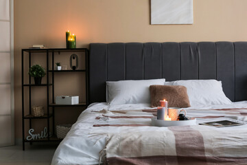 Interior of bedroom with burning candles