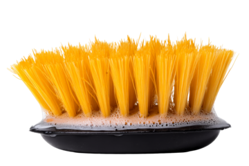 Yellow bristle cleaning brush with soap bubbles