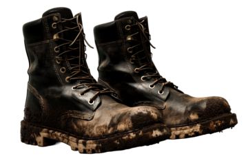 Heavy duty work boots with mud and dirt on a transparent background